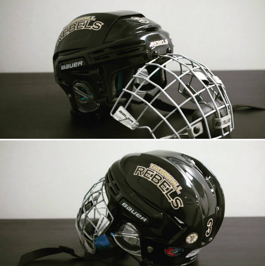 Hockey helmet with cage featuring Rebels Decal set with logos and numebrs
